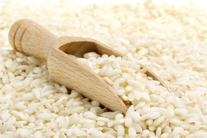 backdrop of risotto rice with wooden scoop